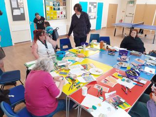 A photo of a craft activity on large tables